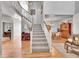Open concept living room flows to staircase and dining room with hardwood floors at 24316 E Ottawa Ave, Aurora, CO 80016