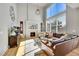Spacious living room with a fireplace, plush seating, and a large window at 24316 E Ottawa Ave, Aurora, CO 80016