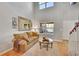 Inviting living room showcasing hardwood floors, large windows, and elegant decor at 24316 E Ottawa Ave, Aurora, CO 80016