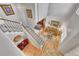 Open-concept living room with hardwood floors and a cozy seating area with a view of the stairs at 24316 E Ottawa Ave, Aurora, CO 80016