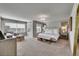 Spacious main bedroom with a sitting area, large windows, and neutral decor at 24316 E Ottawa Ave, Aurora, CO 80016