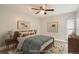 Relaxing bedroom with light walls, modern fan and wood-look floors at 3663 S Sheridan Blvd # J12, Denver, CO 80235