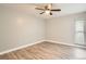 Bedroom featuring wood-look floors, a ceiling fan, and natural light from the window at 3663 S Sheridan Blvd # J12, Denver, CO 80235