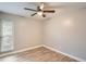 Neutral bedroom with wood-look flooring and a ceiling fan at 3663 S Sheridan Blvd # J12, Denver, CO 80235