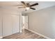 Bedroom featuring wood-look flooring, ceiling fan, and closet at 3663 S Sheridan Blvd # J12, Denver, CO 80235