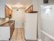 Kitchen features wood cabinets, stainless steel double sink, and a full size white refrigerator at 3663 S Sheridan Blvd # J12, Denver, CO 80235