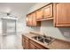 Functional kitchen with stainless steel sink, wood cabinets, and modern flooring at 3663 S Sheridan Blvd # J12, Denver, CO 80235