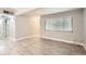 Empty living room with light-colored flooring, bright light, and neutral walls at 3663 S Sheridan Blvd # J12, Denver, CO 80235