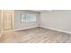 Spacious empty living room with sleek, light-colored flooring and a large window at 3663 S Sheridan Blvd # J12, Denver, CO 80235