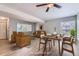 Open-concept living and dining area featuring modern furnishings and plenty of natural light at 3663 S Sheridan Blvd # J12, Denver, CO 80235