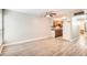 Spacious living room featuring wood laminate flooring, ceiling fan and warm wood cabinets in kitchen at 3663 S Sheridan Blvd # J12, Denver, CO 80235