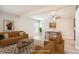 Bright living room features neutral paint, ceiling fan, and wood-look floors for modern appeal at 3663 S Sheridan Blvd # J12, Denver, CO 80235