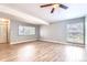 Spacious living room with hardwood floors, ample lighting, and large windows at 3663 S Sheridan Blvd # J12, Denver, CO 80235