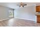 Large living room boasts a ceiling fan, window views, and wood-look laminate flooring at 3663 S Sheridan Blvd # J12, Denver, CO 80235