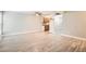 Open layout living area with views to kitchen, bright light, and light colored flooring at 3663 S Sheridan Blvd # J12, Denver, CO 80235