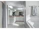 Bathroom featuring double vanity sinks, tile floors, a large mirror, and a soaking tub at 10141 Autumn Blaze Trl, Highlands Ranch, CO 80129
