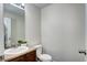 Powder room features neutral walls, vanity with sink, and a toilet at 10141 Autumn Blaze Trl, Highlands Ranch, CO 80129