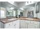 Bathroom features double sinks, a large mirror, decorative tile and updated cabinets and hardware at 10141 Autumn Blaze Trl, Highlands Ranch, CO 80129