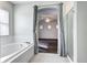 Bright bathroom boasts tub, shower and arched doorway to bedroom with neutral colors and natural light at 10141 Autumn Blaze Trl, Highlands Ranch, CO 80129