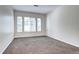 Neutral bedroom has a large window and neutral carpet at 10141 Autumn Blaze Trl, Highlands Ranch, CO 80129