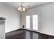 Bright dining area with modern lighting, hardwood floors, and access to a patio at 10141 Autumn Blaze Trl, Highlands Ranch, CO 80129