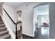 Hallway with hardwood floors showcases staircase and arched doorways, and a glimpse of other rooms at 10141 Autumn Blaze Trl, Highlands Ranch, CO 80129