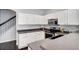 Well-lit kitchen features modern stainless steel appliances, white cabinetry, and neutral countertops at 10141 Autumn Blaze Trl, Highlands Ranch, CO 80129