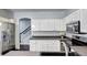 Well-equipped kitchen features stainless steel appliances, white cabinets, and easy access to stairs at 10141 Autumn Blaze Trl, Highlands Ranch, CO 80129