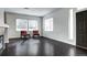 Bright living room with a fireplace, hardwood floors, and large windows for plenty of natural light at 10141 Autumn Blaze Trl, Highlands Ranch, CO 80129