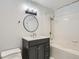 Updated bathroom featuring modern vanity, elegant mirror, and shower-tub combo at 300 W 11Th Ave # 5I, Denver, CO 80204