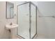 Bright bathroom features a sleek glass-enclosed shower and modern pedestal sink at 300 W 11Th Ave # 5I, Denver, CO 80204