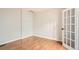 Empty bedroom with hardwood floors, neutral paint, and French-style doors at 300 W 11Th Ave # 5I, Denver, CO 80204