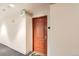 Unit entrance with a warm wood door and welcome mat for guests at 300 W 11Th Ave # 5I, Denver, CO 80204