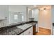 Pass-through kitchen counter, granite countertop, and sink with a view to the living room at 300 W 11Th Ave # 5I, Denver, CO 80204