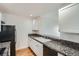 Efficient kitchen with granite countertops and white cabinetry at 300 W 11Th Ave # 5I, Denver, CO 80204