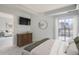 Sunlit main bedroom boasts a city view, walkout balcony, and wood dresser at 300 W 11Th Ave # 5I, Denver, CO 80204