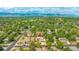 Aerial view showcasing a home nestled among lush greenery at 7591 S Reed Ct, Littleton, CO 80128