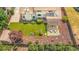 Aerial view of backyard featuring artificial turf, pergola, landscaping, and play area at 7591 S Reed Ct, Littleton, CO 80128