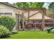 Landscaped backyard features a pergola-covered patio with comfortable seating, a grill, and a play area at 7591 S Reed Ct, Littleton, CO 80128