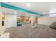 Spacious finished basement with carpet, recreational space and colorful accents at 7591 S Reed Ct, Littleton, CO 80128