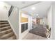 Finished basement features carpet and ample lighting with play area and staircase at 7591 S Reed Ct, Littleton, CO 80128
