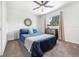 Bedroom with blue bedding and a stylish dresser with mirror at 7591 S Reed Ct, Littleton, CO 80128