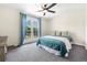 Cozy bedroom featuring a ceiling fan and access to a balcony at 7591 S Reed Ct, Littleton, CO 80128
