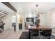 Dining area featuring a modern table, stylish chairs, and an open view into the kitchen at 7591 S Reed Ct, Littleton, CO 80128