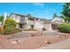 Two-story home with stone-terraced front yard and lush landscaping, blending curb appeal and modern design at 7591 S Reed Ct, Littleton, CO 80128