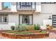 Charming front yard with flower beds and brick accents enhancing curb appeal at 7591 S Reed Ct, Littleton, CO 80128