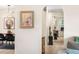 Interior hallway view with archway, neutral colors, decorative accents, and stylish light fixture at 7591 S Reed Ct, Littleton, CO 80128