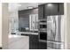 Well-equipped kitchen features stainless steel appliances and stylish cabinetry at 7591 S Reed Ct, Littleton, CO 80128