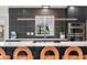 Modern kitchen showcasing dark cabinets, a sleek countertop, and stainless steel appliances at 7591 S Reed Ct, Littleton, CO 80128