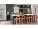 Kitchen features modern island with seating at 7591 S Reed Ct, Littleton, CO 80128